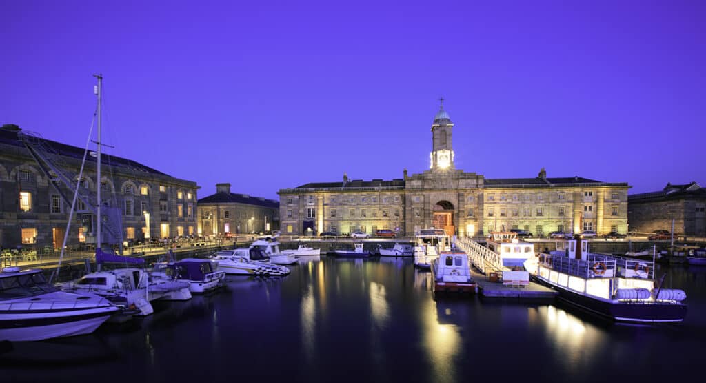 A low light night scene of the Royal William yard harbour. This is a nearly developed part of Plymouth which host a number of restraints and a leisure harbour. A popular place for visitors to the city.The picture was captured at night which a long exposure creating some movement in the water and boats.
